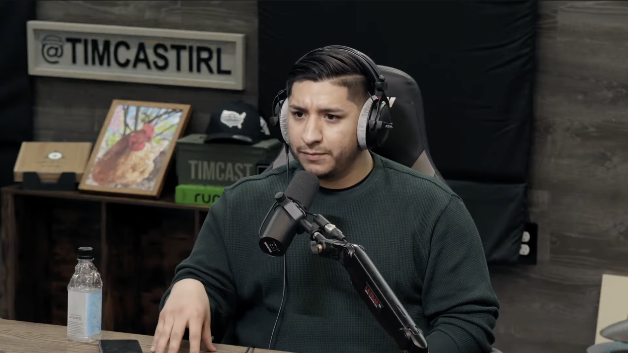 Eleazar speaking into a microphone at the Timcast studio